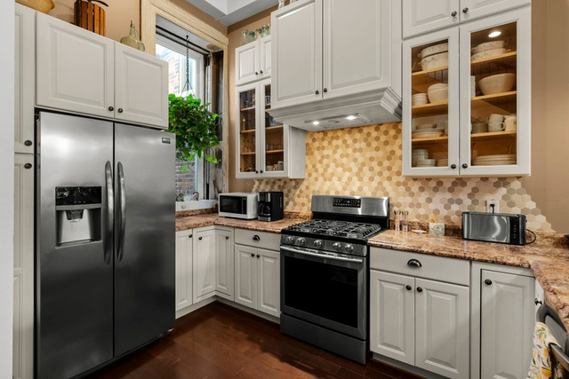 Custom kitchen cabinetry and stainless appliances